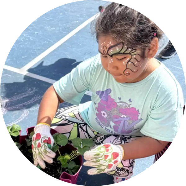 Young girl planting flowers