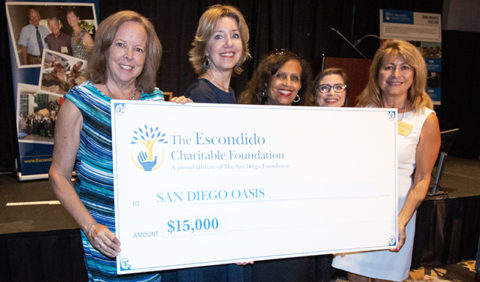 Representatives from San Diego Oasis hold up a commemorative check for their Escondido Charitable Foundation grant