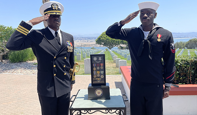 Henry Cook (left) and Tyshawn Cook (right) saluting a family member farewell who retired from the service.