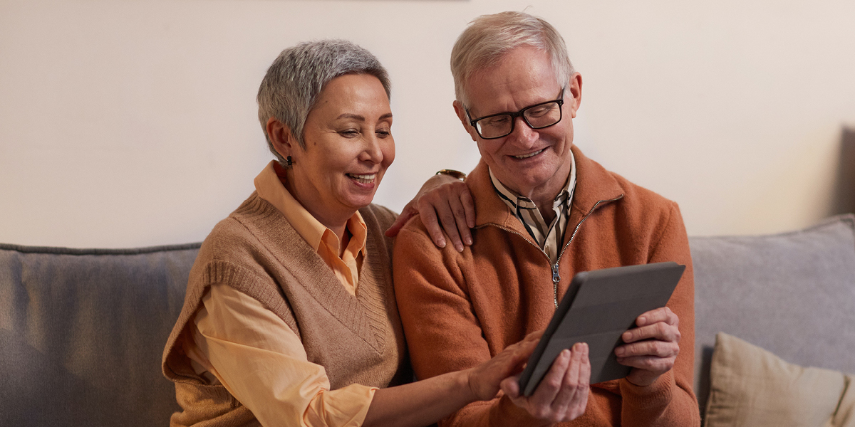 Couple researching on tablet