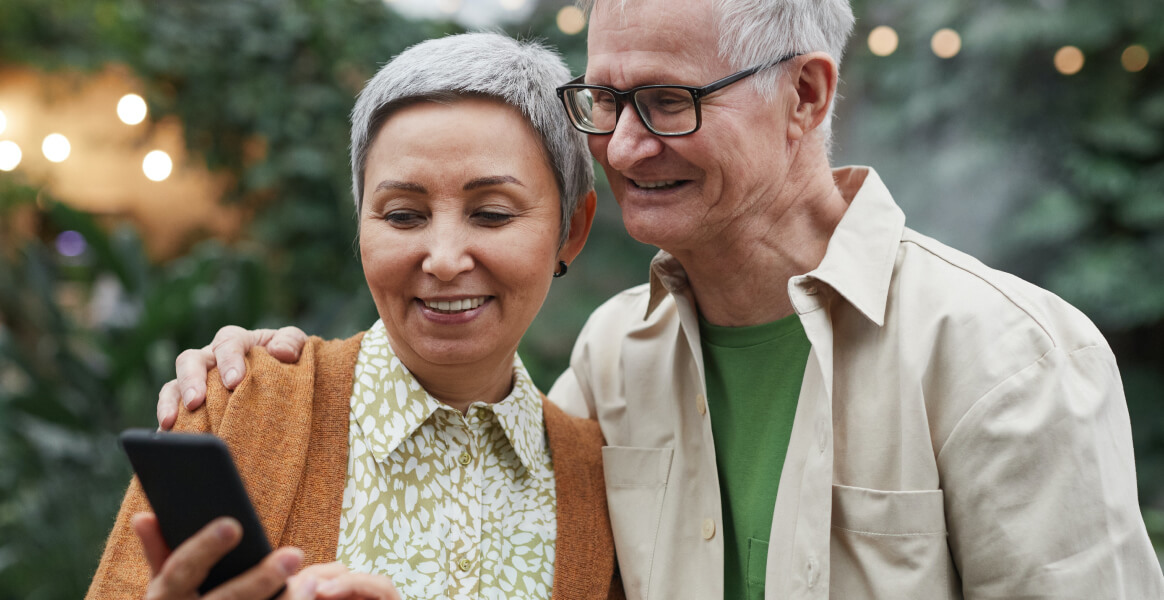 Elderly couple looking at cellphone