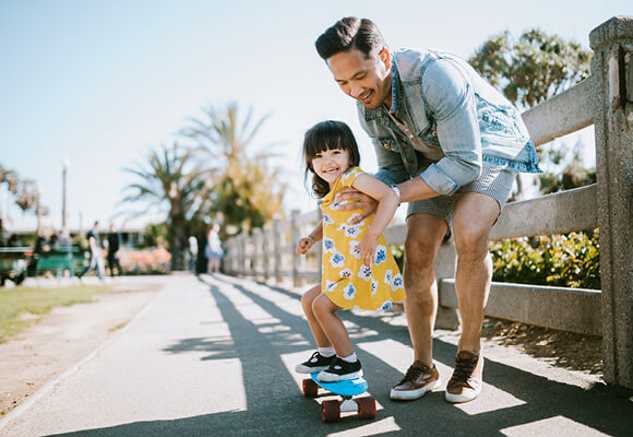 Father and daughter skateboarding