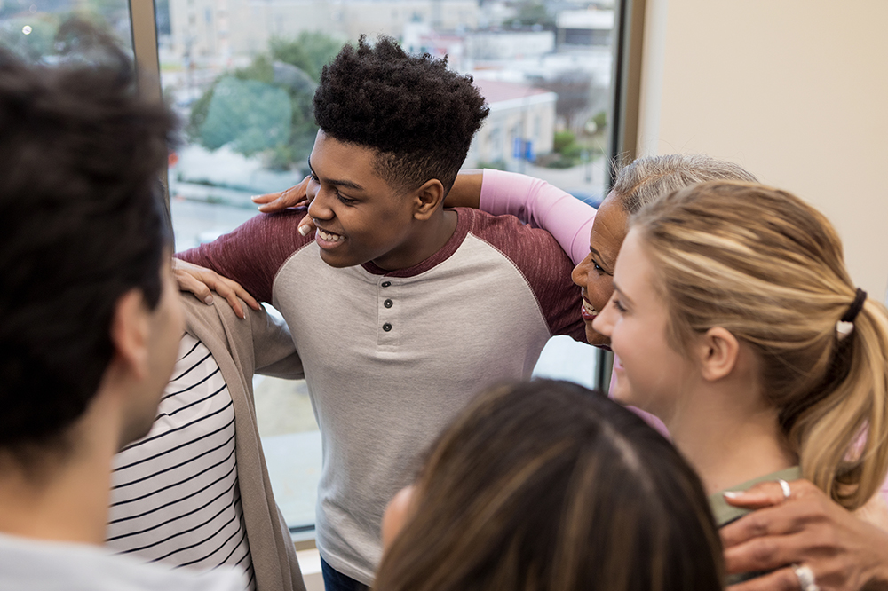 Multi-ethnic group celebrates when a member is successful