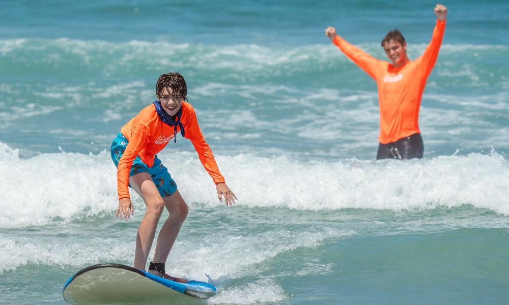 Youth surfing as part of the Level Up SD Summer 2023 program
