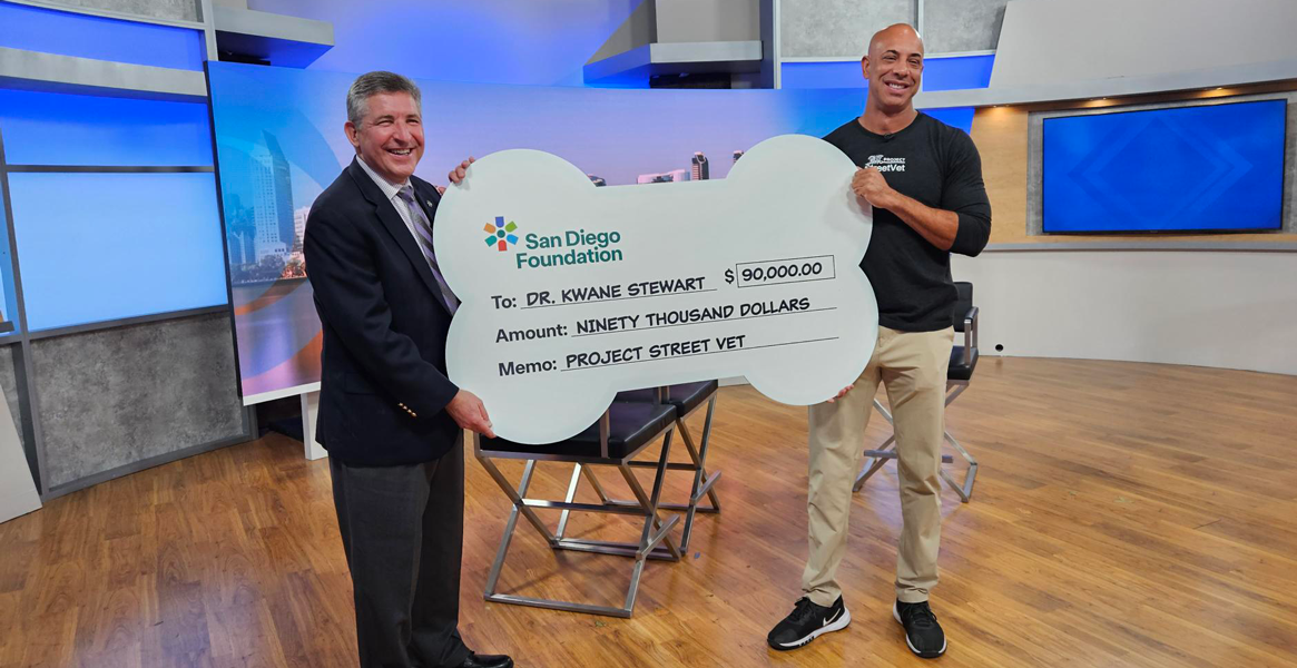 Mark Stuart and Dr. Kwane Stewart with giant check
