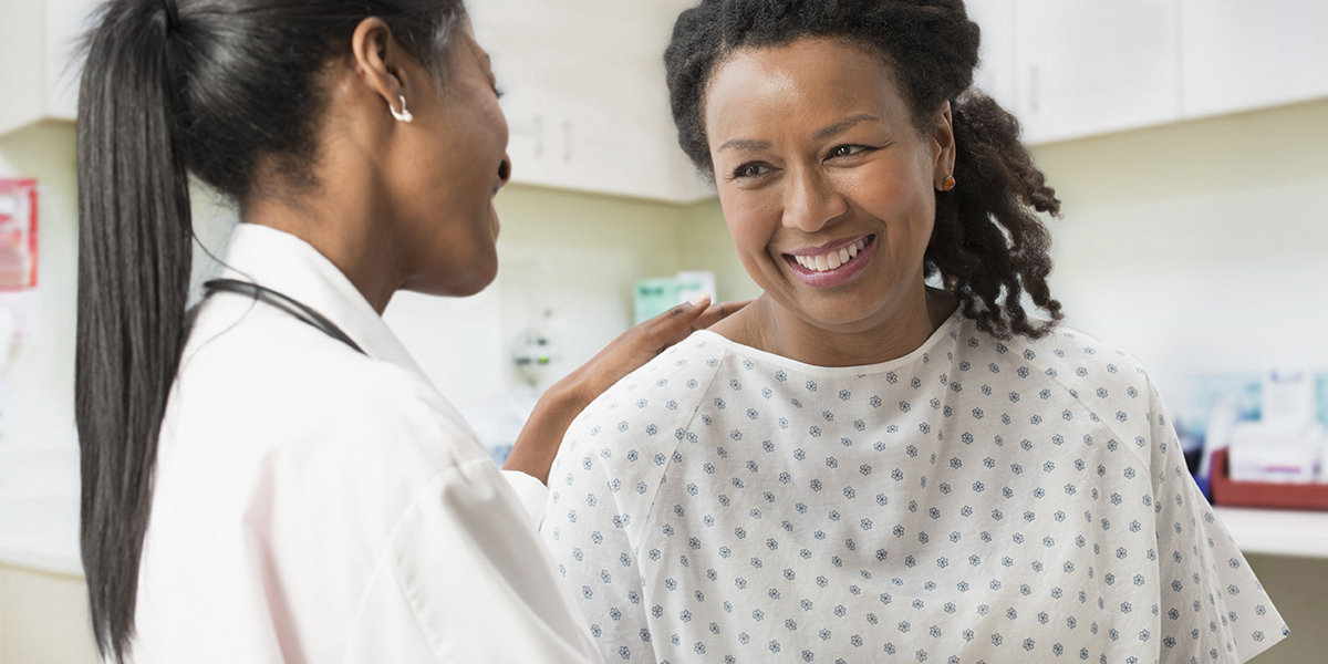 Doctor comforting patient in office