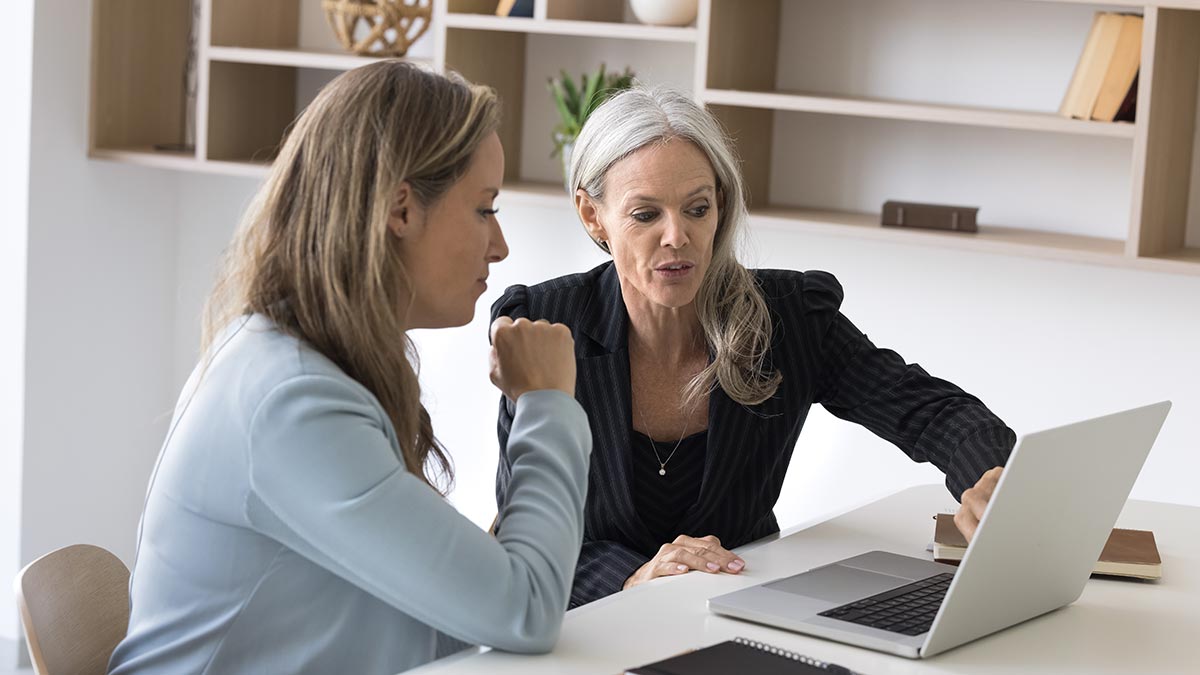 Advisory discussing client portfolio on laptop