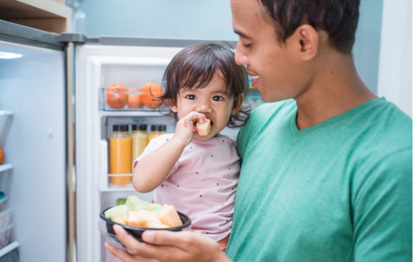 Toddler eating fresh fruit