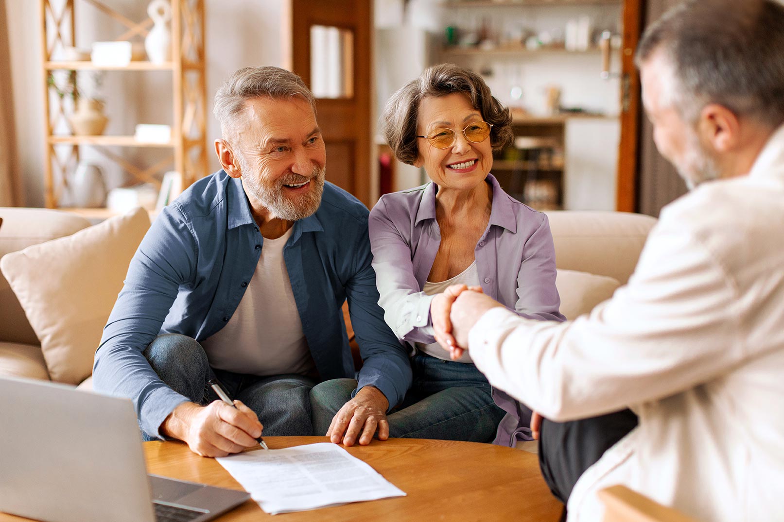 Advisor shaking hands with clients