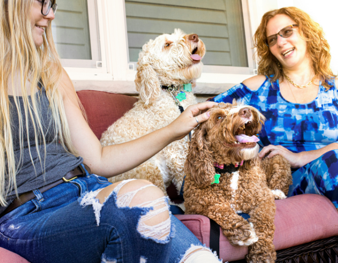 Women enjoying the company of dogs