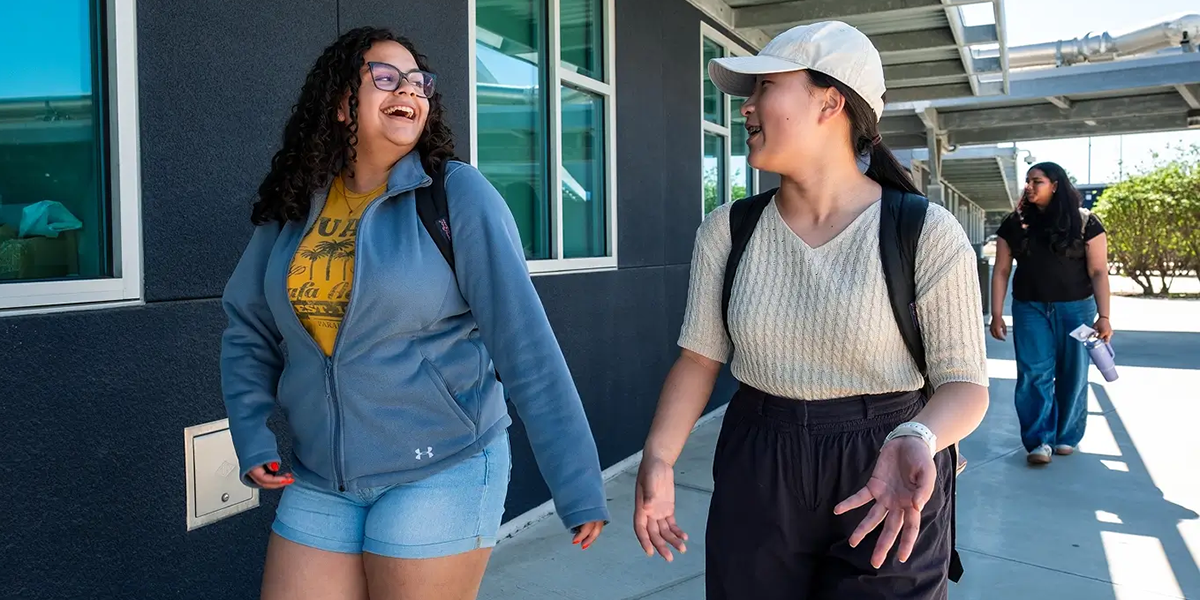 Two young women talking and laughing