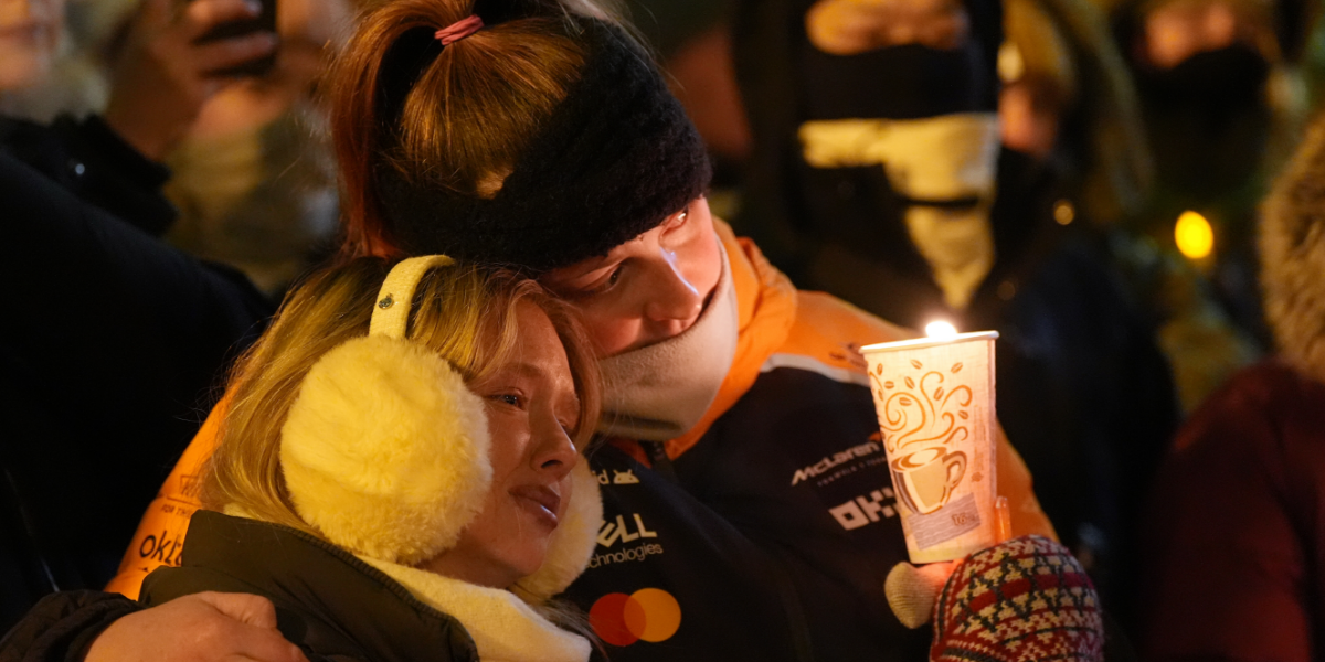 Two women attend a Minneapolis candle vigil