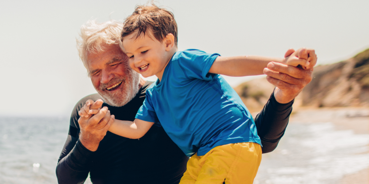 Grandfather and grandson on the beach