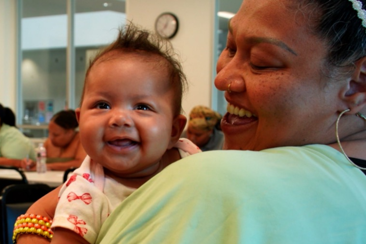 Happy baby and woman smiling