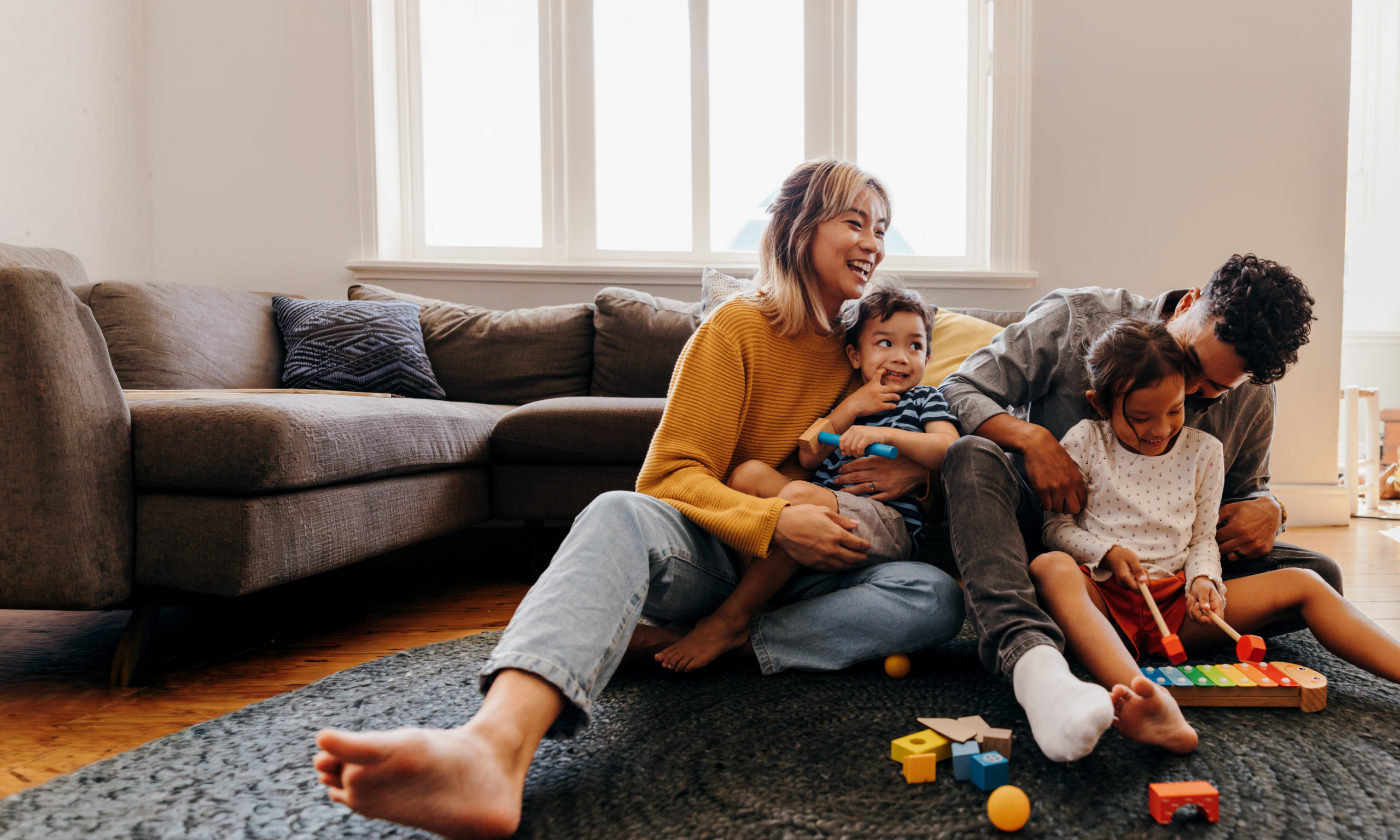 Young family at home in their living room